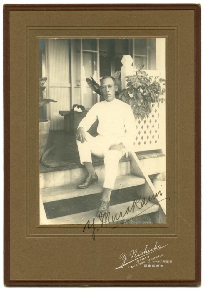 A man sitting on the steps of a house. 